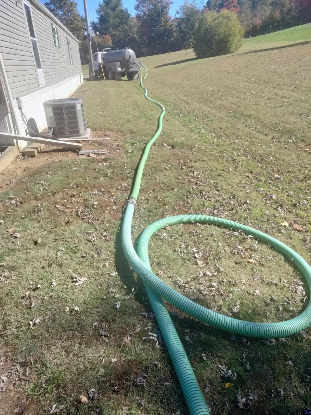 Pump hose running across a yard back to the truck