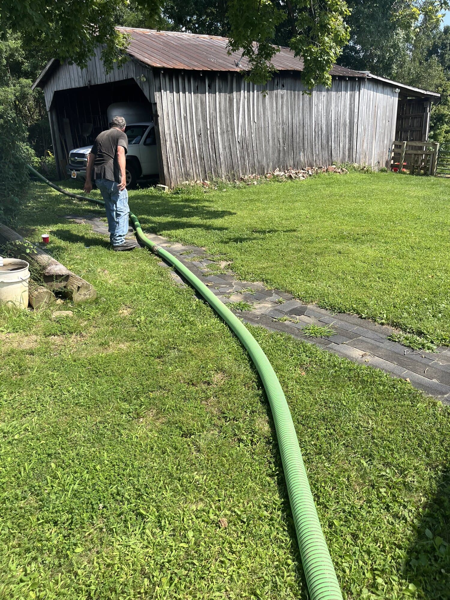 Quick Pump and Clean worker running the service hose during a septic job